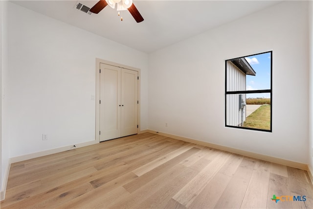 unfurnished bedroom with a closet, ceiling fan, and light hardwood / wood-style floors