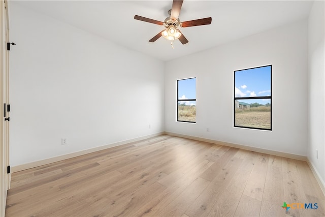 spare room featuring light wood-type flooring and ceiling fan