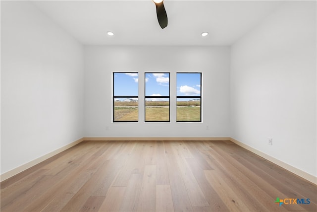 spare room featuring ceiling fan and light hardwood / wood-style floors