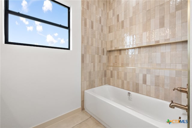 bathroom with tile patterned floors and a bathtub