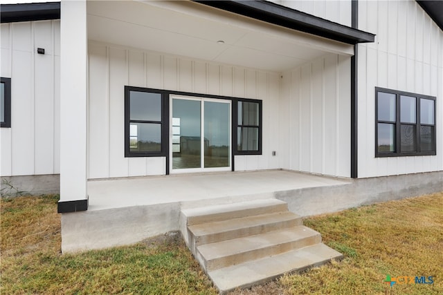 property entrance with a patio and elevator