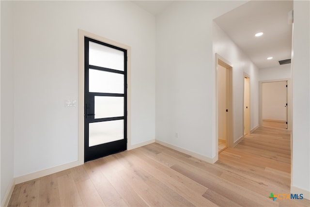 foyer entrance with light hardwood / wood-style floors