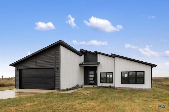 modern farmhouse featuring a garage and a front lawn