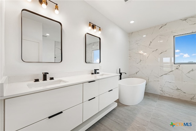 bathroom with a bathtub and vanity