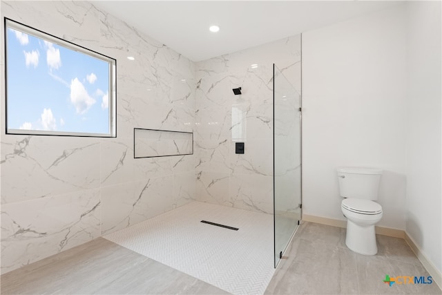 bathroom featuring toilet and tiled shower