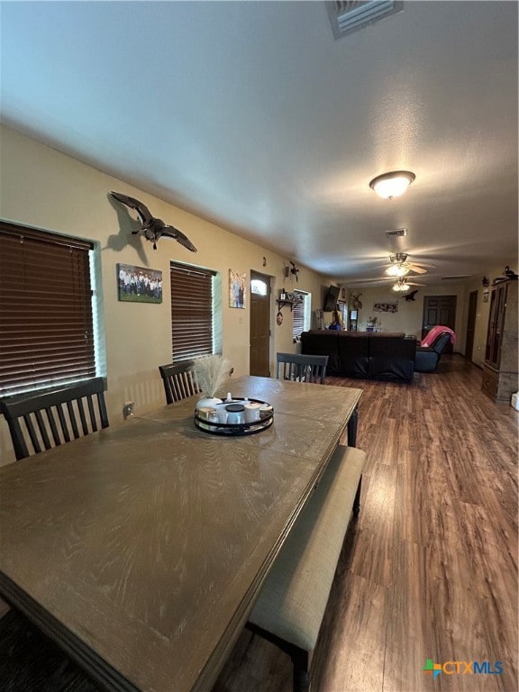 dining space featuring hardwood / wood-style flooring and ceiling fan