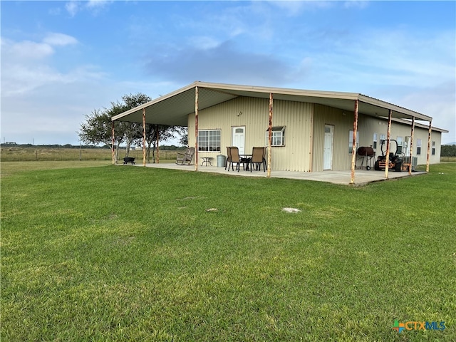 rear view of house featuring a yard