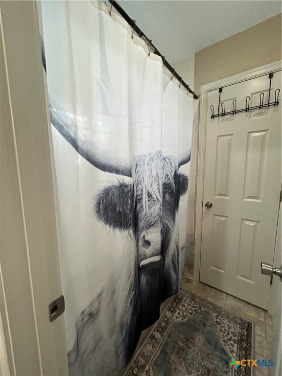 bathroom featuring tile patterned floors and walk in shower