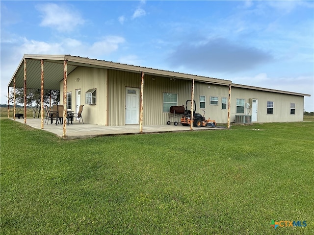 back of house featuring a patio area, a yard, and central air condition unit