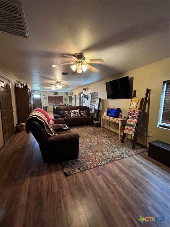 living room featuring hardwood / wood-style floors and ceiling fan