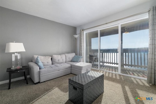 carpeted living room featuring a water view