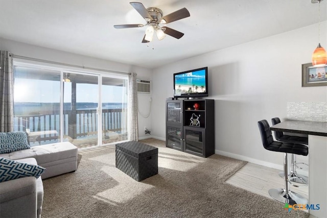 carpeted living room featuring ceiling fan and a wall unit AC