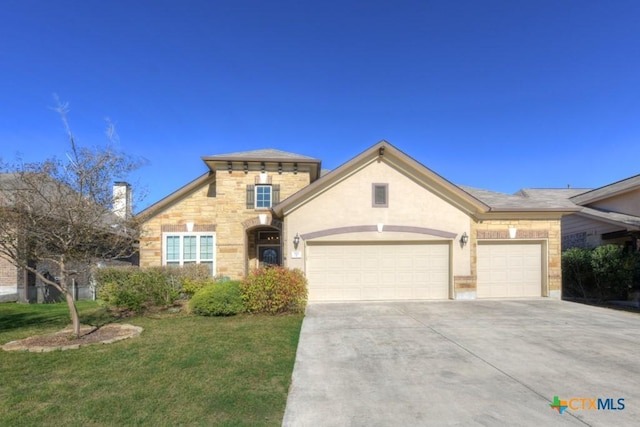 view of front of property with a front lawn and a garage