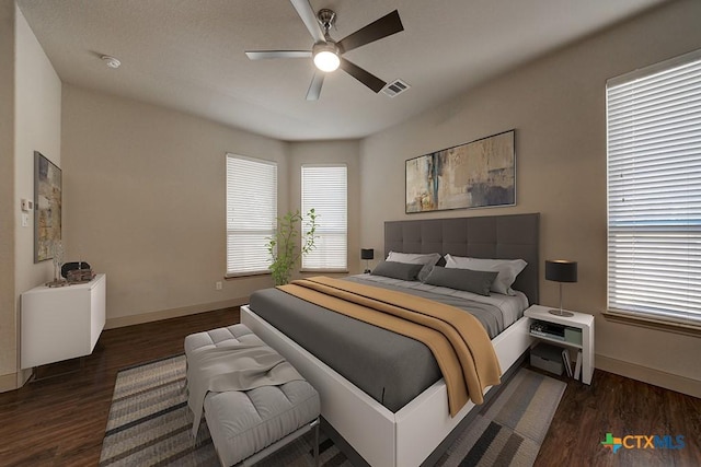 bedroom featuring ceiling fan and dark wood-type flooring