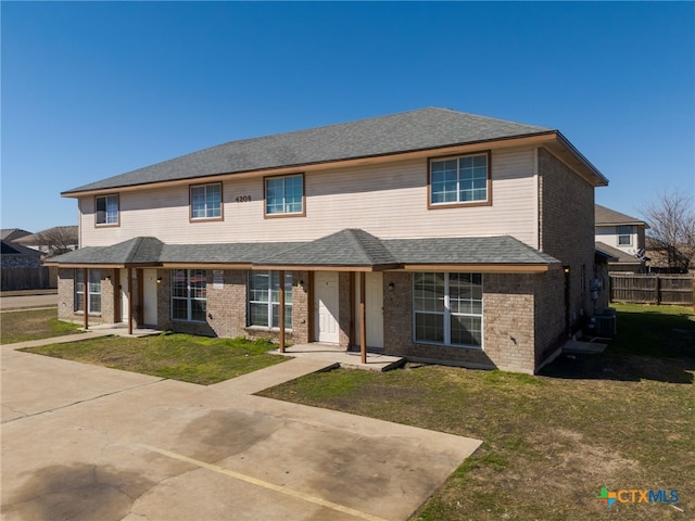 view of front of house featuring central AC, a patio area, and a front yard