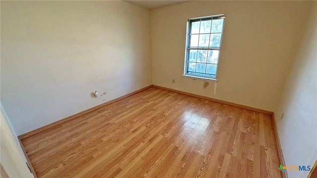 spare room featuring light hardwood / wood-style flooring