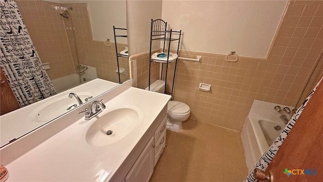 bathroom featuring vanity, tile walls, and toilet