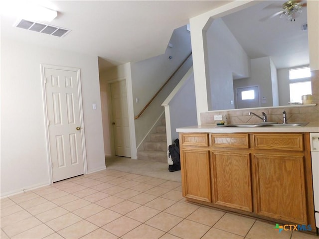 2302 Napier Dr, Killeen, TX 76542 - kitchen featuring a sink, light countertops, a ceiling fan, light tile patterned flooring, and tasteful backsplash