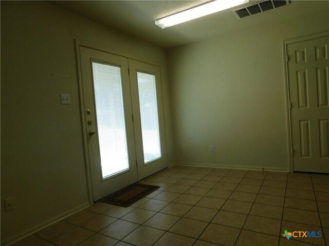 2302 Napier Dr, Killeen, TX 76542 - doorway featuring light tile patterned floors, baseboards, and french doors