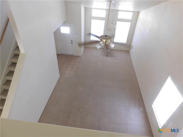 2302 Napier Dr, Killeen, TX 76542 - unfurnished living room with plenty of natural light, stairway, and tile patterned flooring