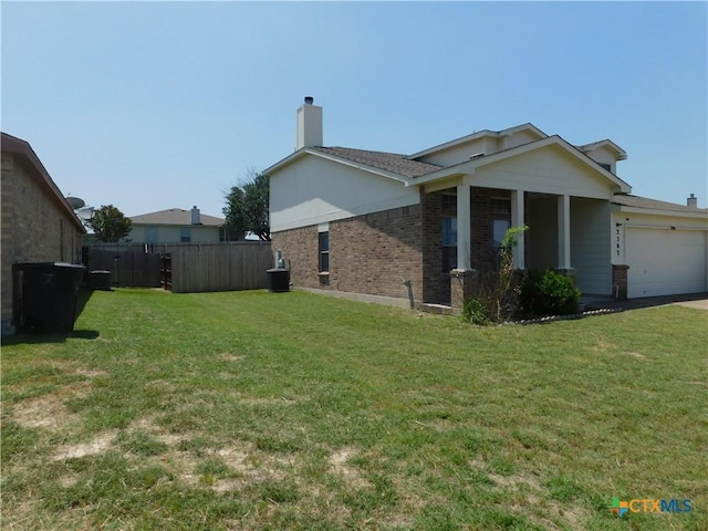 2302 Napier Dr, Killeen, TX 76542 - view of property exterior featuring brick siding, an attached garage, a chimney, cooling unit, and driveway