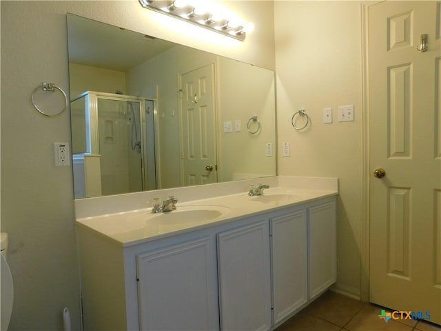 2302 Napier Dr, Killeen, TX 76542 - bathroom with a stall shower, tile patterned floors, double vanity, and toilet