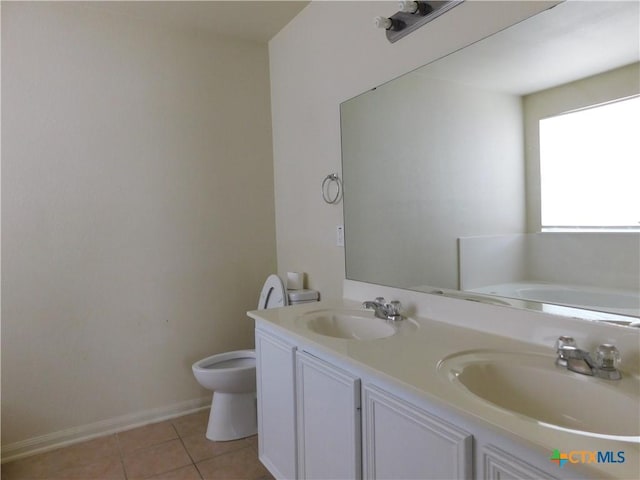 2302 Napier Dr, Killeen, TX 76542 - bathroom with toilet, double vanity, tile patterned floors, baseboards, and a garden tub