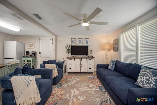 819 S Magnolia St, Rockport, TX 78382 - living area featuring ceiling fan, wood finished floors, and a textured ceiling