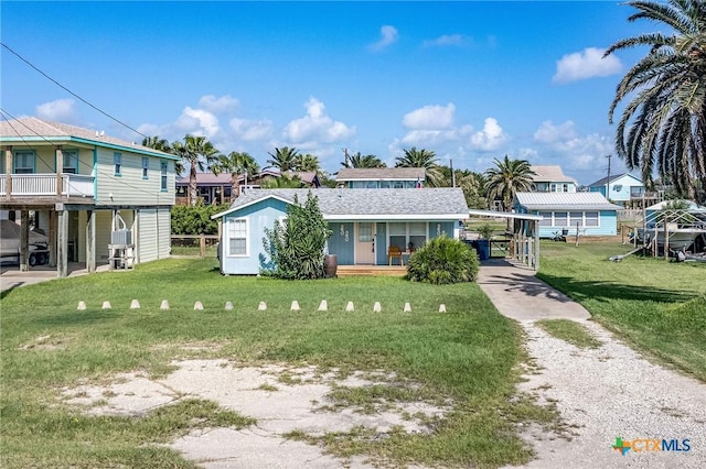 819 S Magnolia St, Rockport, TX 78382 - view of front of property with a front yard, driveway, a carport, and covered porch