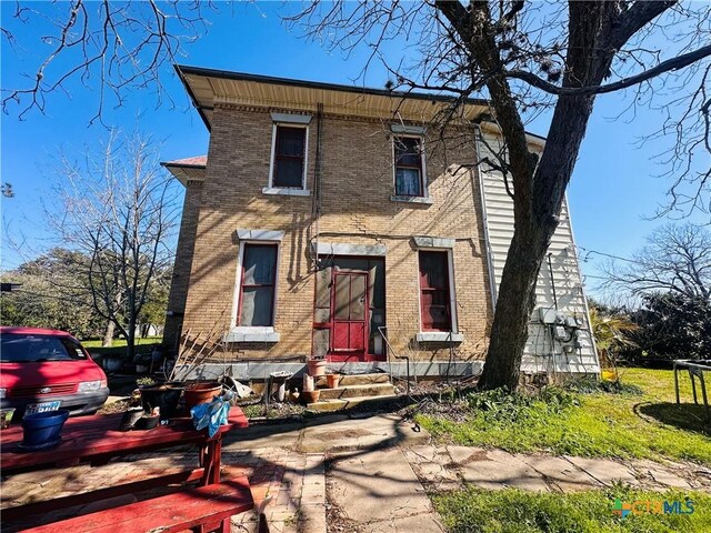 view of front of property featuring brick siding