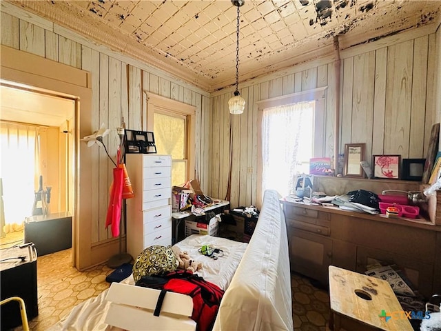 bedroom featuring an ornate ceiling and wooden walls