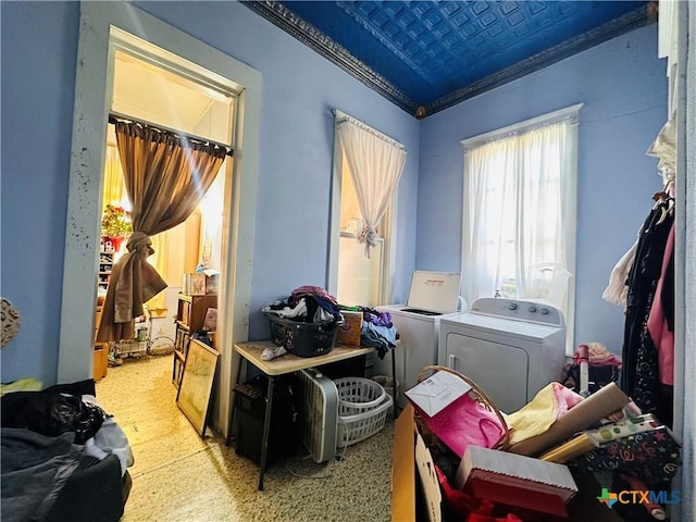 clothes washing area featuring laundry area, an ornate ceiling, ornamental molding, and washer and clothes dryer