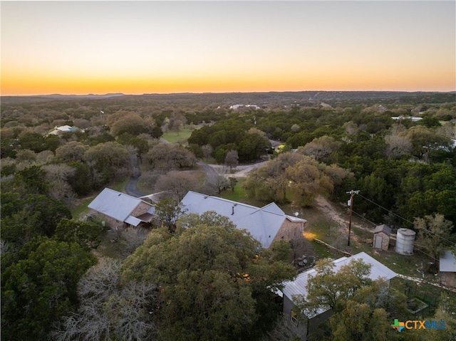 birds eye view of property with a forest view