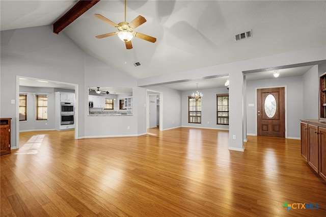 unfurnished living room featuring beam ceiling, light wood-type flooring, baseboards, ceiling fan with notable chandelier, and visible vents