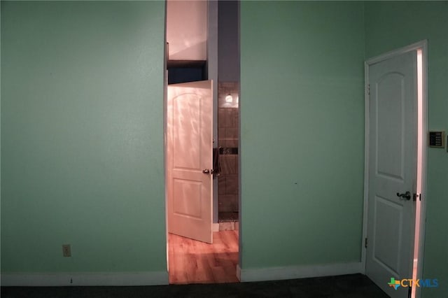 22631 John Rolfe Ln, Katy, TX 77449 - hallway featuring baseboards and wood finished floors