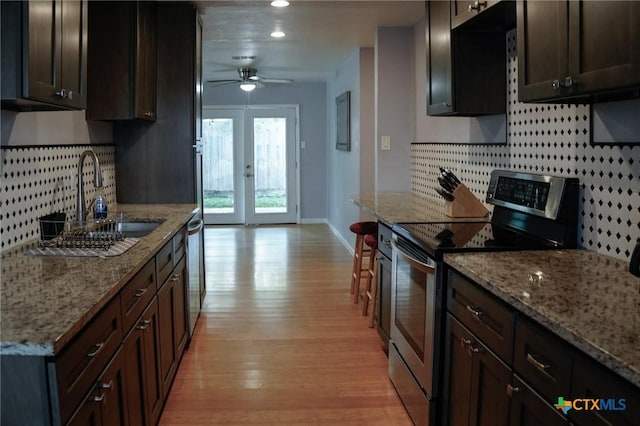 22631 John Rolfe Ln, Katy, TX 77449 - kitchen with stainless steel appliances, tasteful backsplash, light wood-style flooring, ceiling fan, and recessed lighting