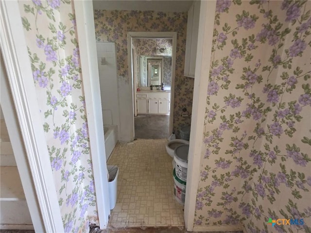 403 Schell Rd, Victoria, TX 77904 - full bathroom with wallpapered walls, vanity, and washtub / shower combination