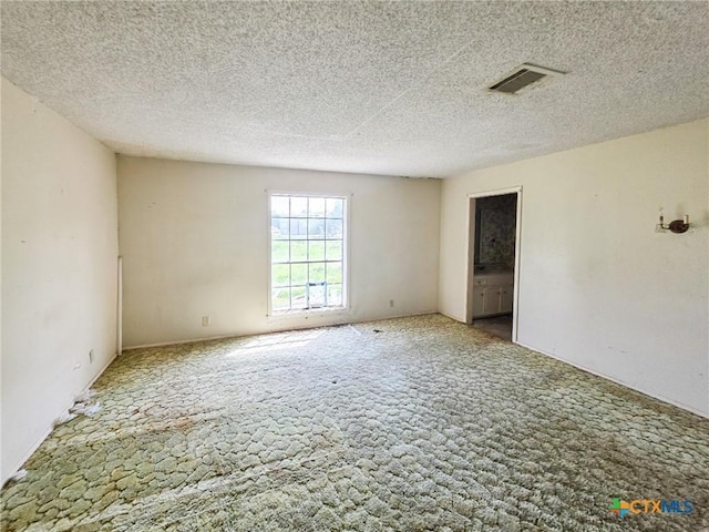403 Schell Rd, Victoria, TX 77904 - spare room with carpet flooring and a textured ceiling