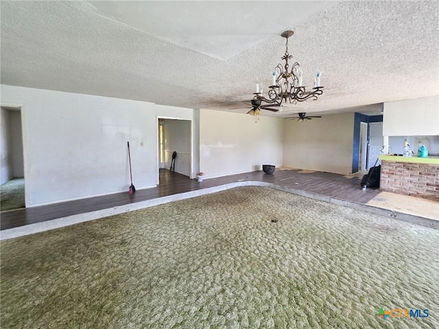 403 Schell Rd, Victoria, TX 77904 - unfurnished living room featuring a ceiling fan, a chandelier, carpet, and a textured ceiling