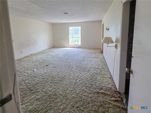 403 Schell Rd, Victoria, TX 77904 - unfurnished room with carpet and a textured ceiling
