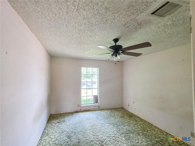 403 Schell Rd, Victoria, TX 77904 - spare room featuring carpet floors, a ceiling fan, and a textured ceiling