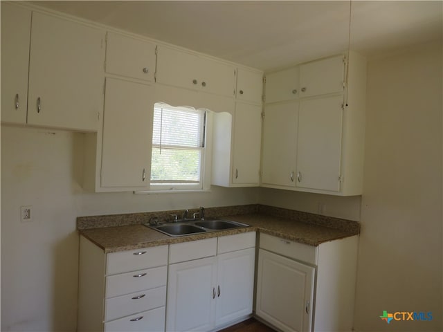 kitchen featuring white cabinets and sink