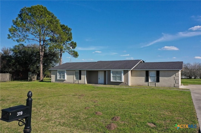 single story home with brick siding and a front yard