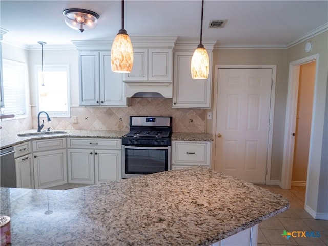 kitchen with visible vents, appliances with stainless steel finishes, crown molding, premium range hood, and a sink