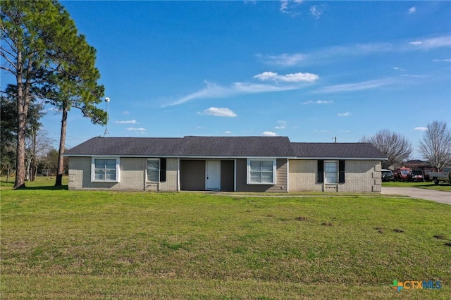 ranch-style home with a front yard and brick siding