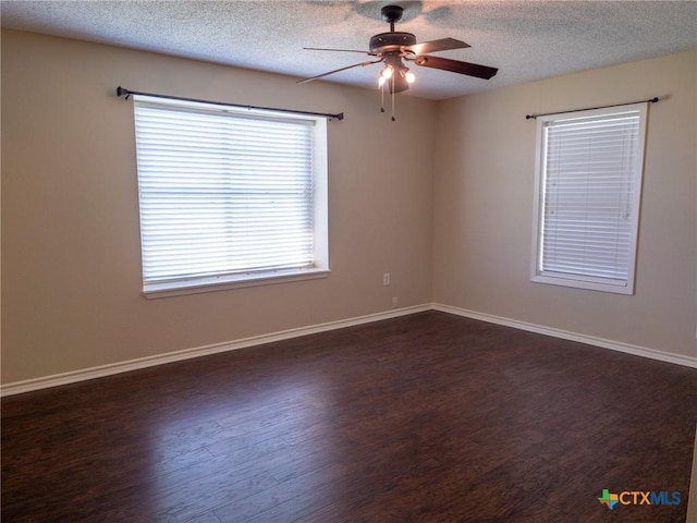 unfurnished room featuring dark wood-style floors, baseboards, and a textured ceiling