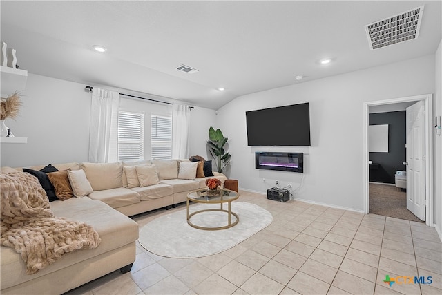 living room featuring vaulted ceiling and light tile patterned floors