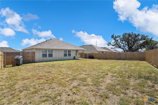 back of house with a yard