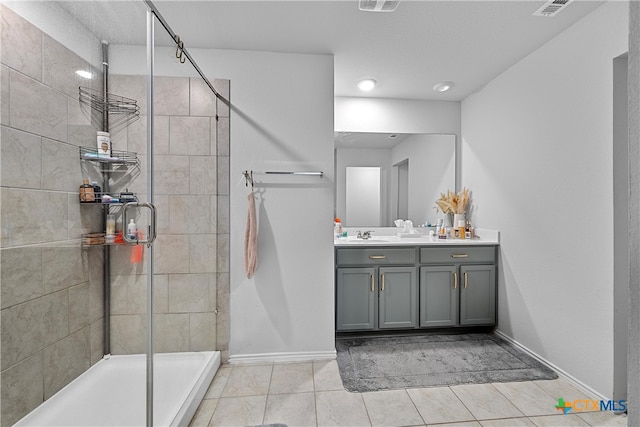 bathroom featuring vanity, tile patterned floors, and tiled shower