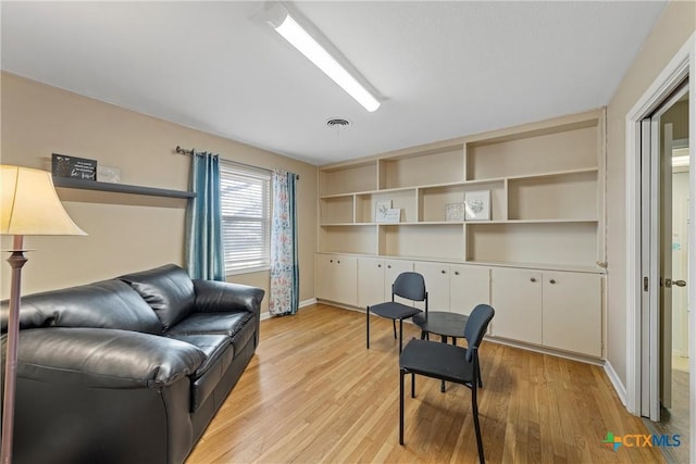 office featuring light wood-style floors, baseboards, and visible vents